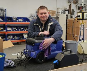 Ein Mitarbeiter reinigt einen Nasssauger.